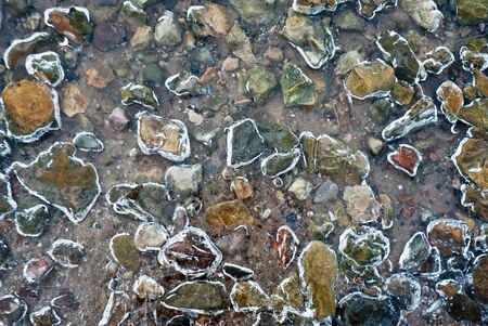 frozen stones and rocks in lake, nature series