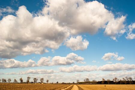 occurring yellow sun behind the clouds on a warm eveningの写真素材