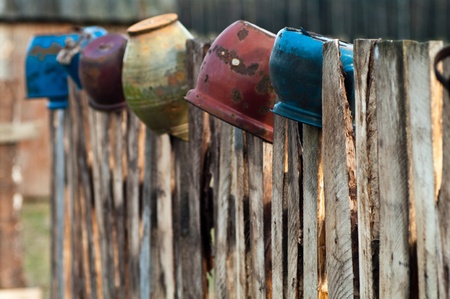 Old wooden boundary fence with nails on sunny dayの写真素材