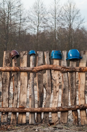 Old wooden boundary fence with nails on sunny dayの写真素材