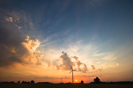 occurring yellow sun behind the clouds on a warm eveningの写真素材