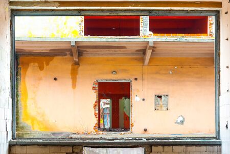 Discarded ruin with old windows and wall, industrial window in concrete wallの写真素材