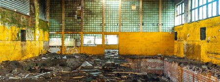 Discarded ruin with old windows and wall, industrial window in concrete wallの写真素材