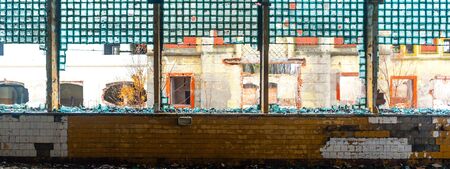 Discarded ruin with old windows and wall, industrial window in concrete wallの写真素材