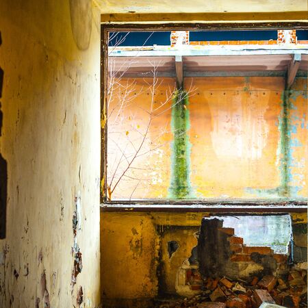 Discarded ruin with old windows and wall, industrial window in concrete wallの写真素材