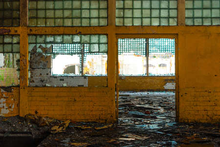 Discarded ruin with old windows and wall, industrial window in concrete wallの写真素材