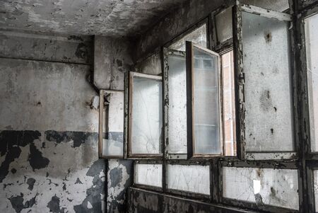 discarded ruin with old windows and wall, industrial window in concrete wall