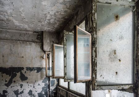 discarded ruin with old windows and wall, industrial window in concrete wallの写真素材