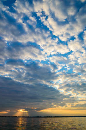 sun behind the clouds on a warm day, nature seriesの写真素材