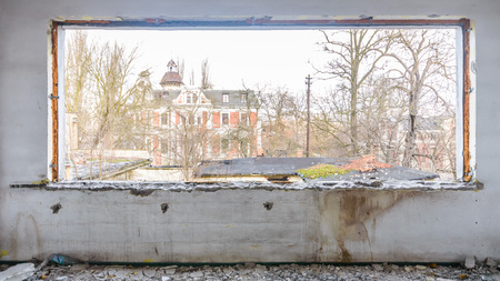 discarded ruin with old windows and wall, industrial window in concrete wallの写真素材
