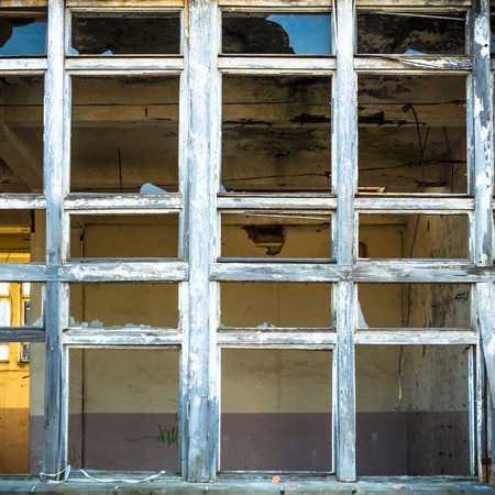 discarded ruin with old windows and wall, industrial window in concrete wall
