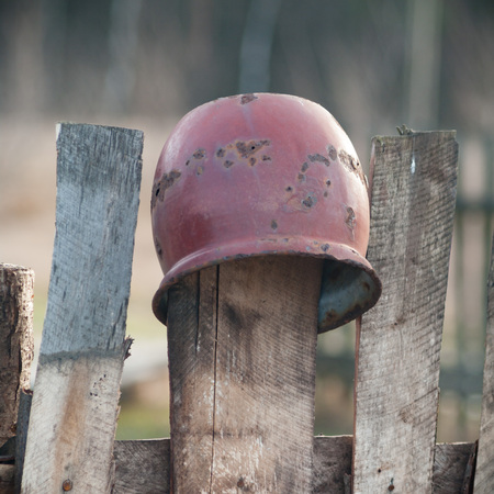 Old wooden boundary fence with nails on sunny dayの写真素材