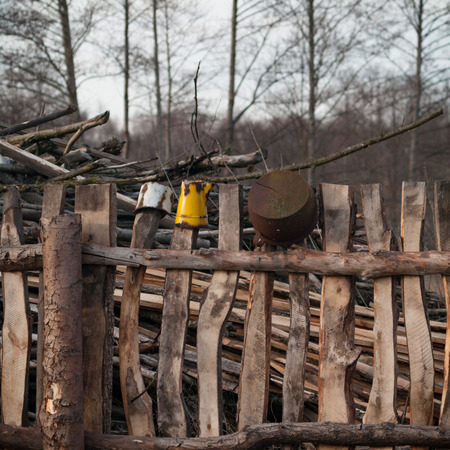 Old wooden boundary fence with nails on sunny dayの写真素材
