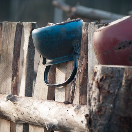 Old wooden boundary fence with nails on sunny dayの写真素材