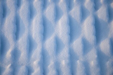 footprints and lines on the snow in winterの写真素材