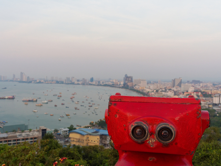 Red binocular on Pattaya beach showing explore and discover new place in tourism industryの写真素材
