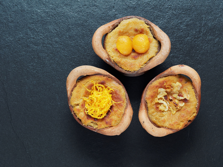 Thai coconut custard pudding dessert, Maw Gaeng, in clay pot on dark backgroundの写真素材