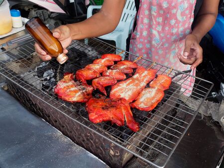 PATTAYA, THAILAND - MAY 25, 2018: Grilled chicken with stick on bbq stove put by pepper powder which is famous street food of Thailandのeditorial素材