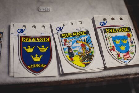 Traditional souvenirs and gifts from Kiruna, Sweden - mugs, fridge magnets, badges, hand made toys, cheese cutters, Lapland, Norrbotten Countyの写真素材