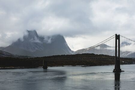 Classic Norwegian cold panoramic landscape of Efjorden fjord, Ballangen municipality, Nordland county, Ofoten district, Norway with Efjord Bridges, Stortinden mountain, Northern Norwayの写真素材