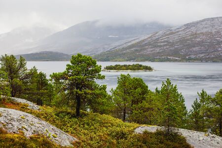 Classic Norwegian cold panoramic landscape of Efjorden fjord, Ballangen municipality, Nordland county, Ofoten district, Norway with Efjord Bridges, Stortinden mountain, Northern Norwayの写真素材