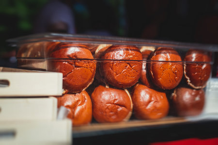 Process of cooking classic burgers with beef on open-air, view of chef hands in gloves with variety of fillings and ingredients on wooden desk and stove, summer dayの写真素材