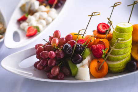 Beautifully decorated catering banquet table with different food snacks and appetizers on corporate christmas birthday event or wedding celebrationの写真素材