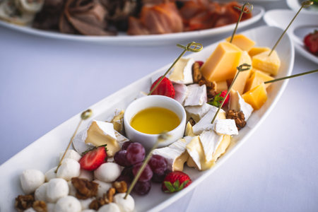 Beautifully decorated catering banquet table with different food snacks and appetizers on corporate christmas birthday event or wedding celebrationの写真素材