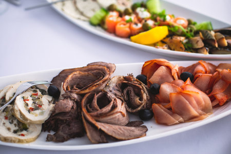 Beautifully decorated catering banquet table with different food snacks and appetizers on corporate...
