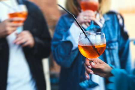 Row line of red colored negroni and spritz aperitif alcohol cocktails on a party of alcohol setting...