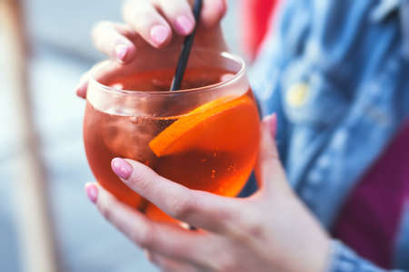 Row line of red colored negroni and spritz aperitif alcohol cocktails on a party of alcohol setting...