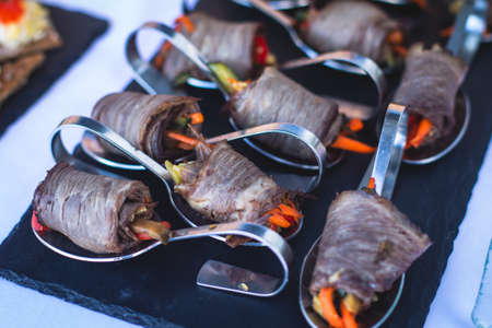 Beautifully decorated catering banquet table with different food snacks and appetizers on corporate...