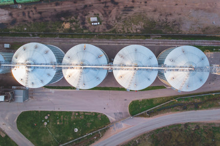 Aerial top view of Grain Elevator Silos, Granary of a feed mill built of modern metal structures, drone shotの写真素材