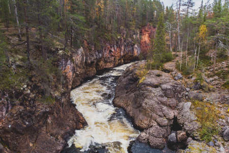 Autumn view of Oulanka National Park, landscape, a Finnish national park in the Northern Ostrobothnia and Lapland regions of Finland, wooden wilderness hut, cabin cottage, bridge, campgroundの写真素材