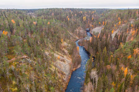 Autumn view of Oulanka National Park, landscape, a Finnish national park in the Northern Ostrobothnia and Lapland regions of Finland, wooden wilderness hut, cabin cottage, bridge, campgroundの写真素材