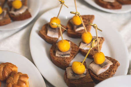 Catering table buffet dinner, beautifully decorated banquet with variety of different food snacks and appetizers on corporate birthday party event or wedding reception, canape, delicatessen assortmentの写真素材