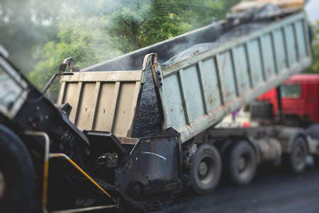 Process of asphalting, blacktopping and paving, asphalt paver machine and steam roller compactor...