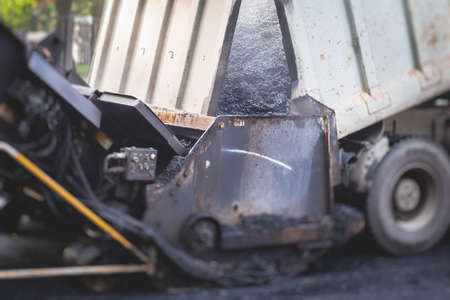 Process of asphalting, blacktopping and paving, asphalt paver machine and steam roller compactor...