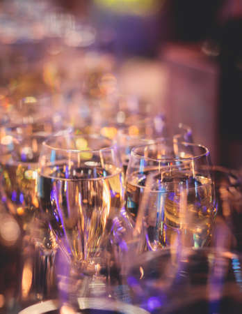Line of alcohol setting on catering banquet table, bartender pouring beverages, row of different...