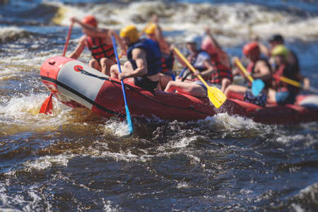Raft boat during whitewater rafting extreme water sports on water rapids, kayaking and canoeing on a...