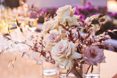 Beautiful wedding ceremony interior and table decor, flower decoration with flowers bouquet, with...