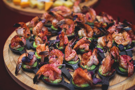 Catering table, beautifully decorated banquet with variety of with different food snacks and appetizers on corporate birthday party event or wedding celebration, seafood, delicatessen settingの写真素材