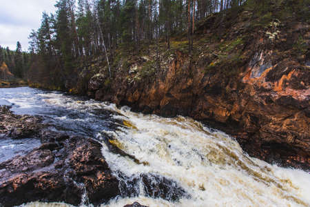 Autumn view of Oulanka National Park, landscape, a Finnish national park in the Northern Ostrobothnia and Lapland regions of Finland, wooden wilderness hut, cabin cottage, bridge, campgroundの写真素材