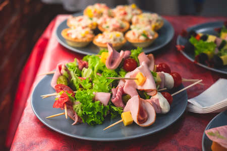 Beautifully decorated catering banquet table with different homemade food snacks and appetizers on...