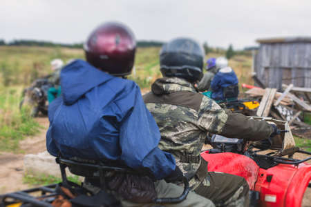 Group of riders riding atv vehicle on off road track, process of driving ATV vehicle, all terrain...