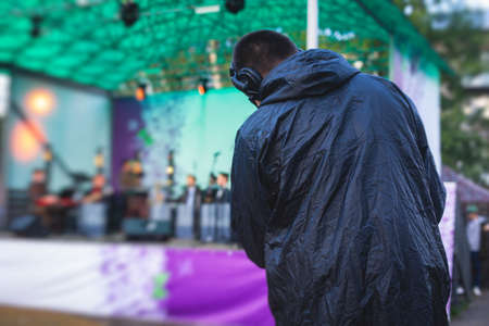 View of a camera man operator working during tv reportage, online broadcasting of concert,...