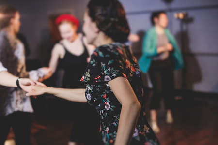 Young couple dance retro jazz swing dances on a ballroom club wooden floor in retro vintage clothes...