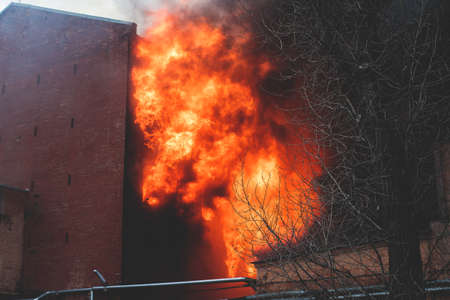 Massive large blaze fire in the city, brick factory building on fire, hell major fire explosion...