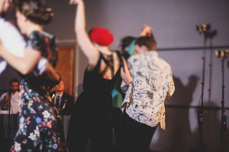 Young couple dance retro jazz swing dances on a ballroom club wooden floor in retro vintage clothes dress, female and male, rock lessons, process of dancingの写真素材