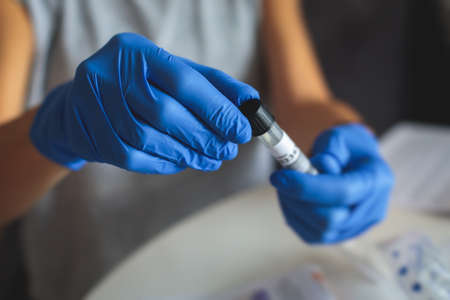 Process of coronavirus testing examination at home, COVID-19 swab collection kit, test tube for...
